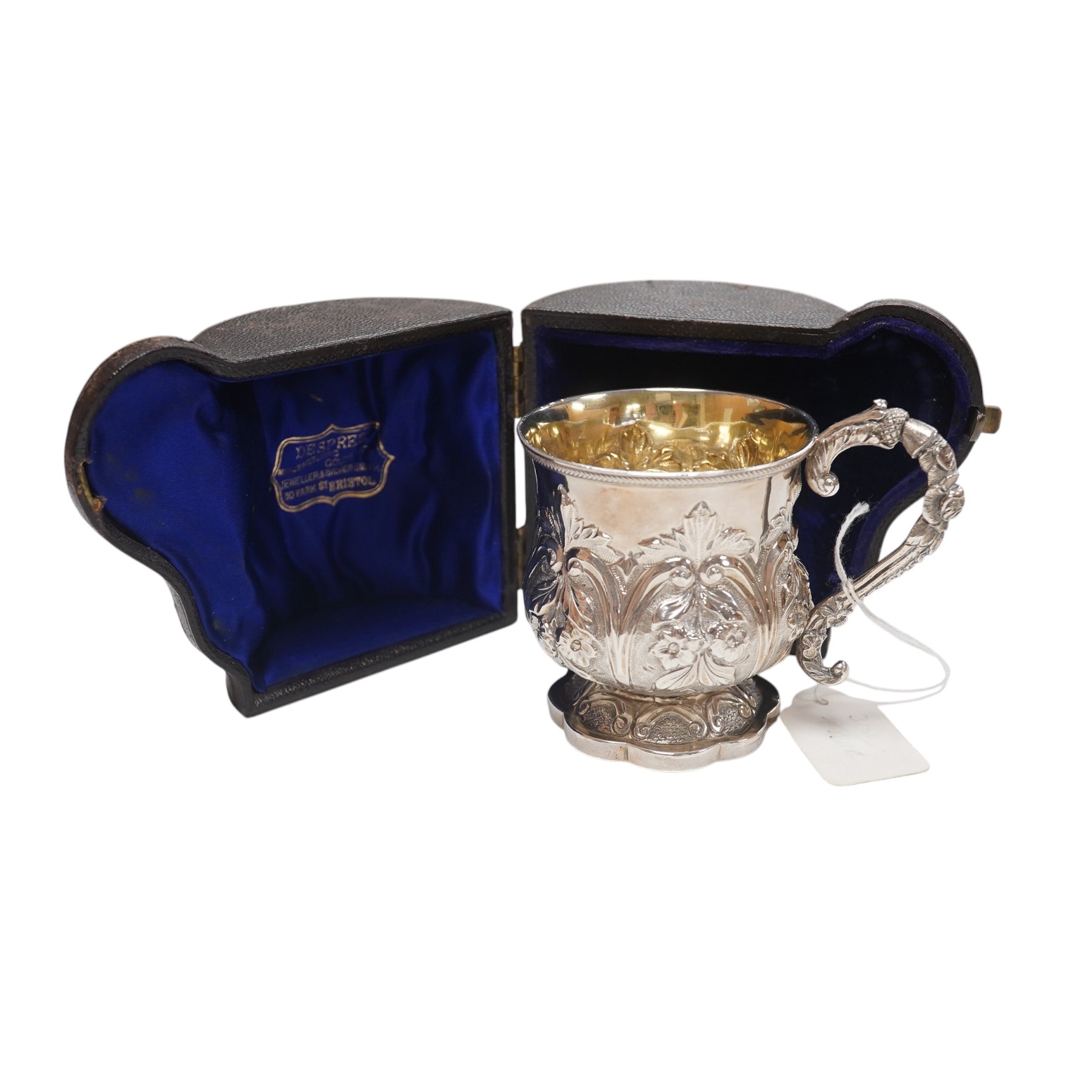 A cased William IV embossed silver pedestal christening mug, with engraved monogram, by Pearce & Burrows, London, 1831, height 77mm, 3.4oz. Condition - fair